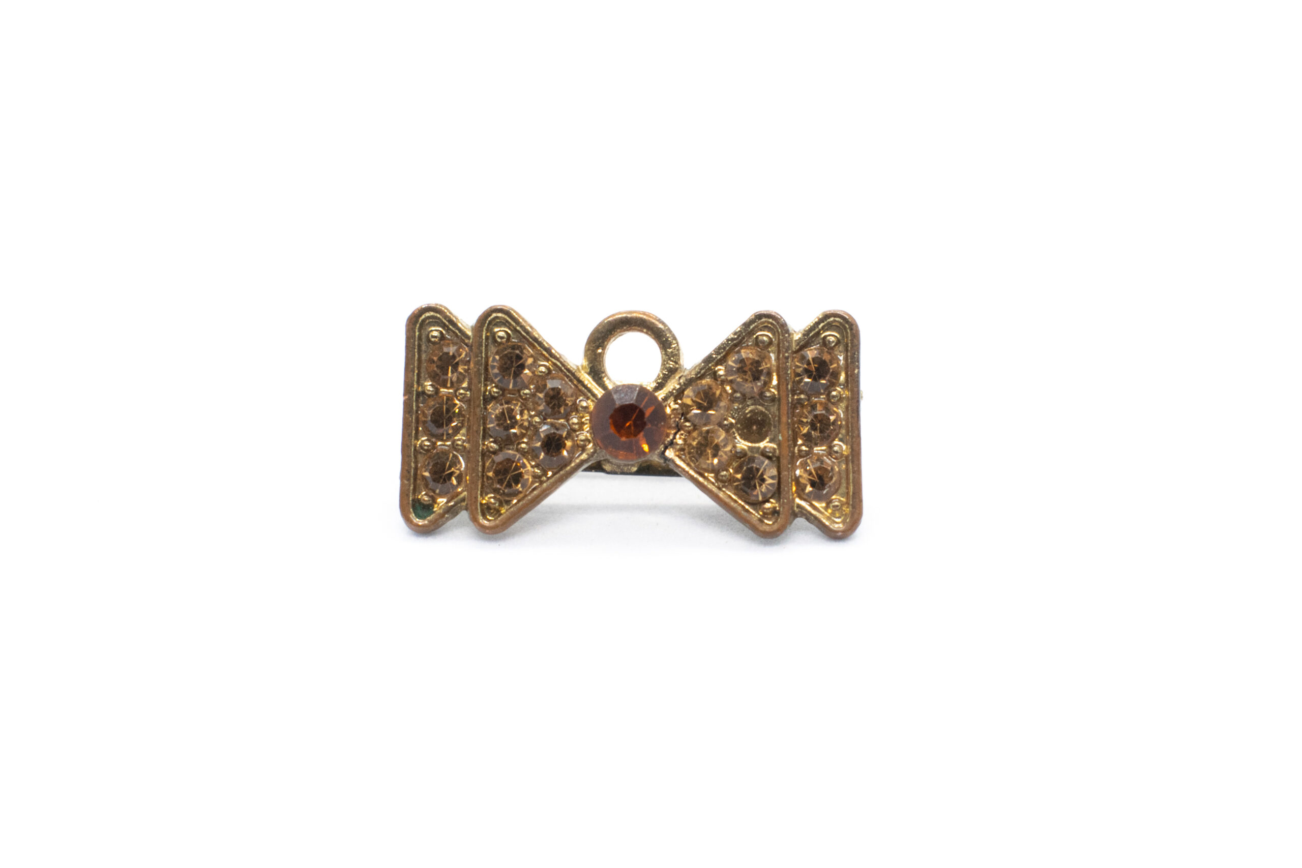 gold bow tie brooch with jewelry on white background